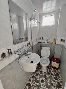 uma casa de banho com um WC branco e um lavatório. em Minh Hiền Hotel em Vung Tau