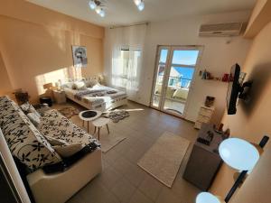 a living room with a couch and a table at Beachside Studio with Sea View - Herceg Novi in Herceg-Novi