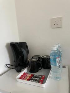 a counter with a toaster and a bottle of water at Casa Lena in Cherating