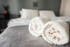 two rolled up towels on top of a bed at M12 Homestay, Butterworth in Butterworth