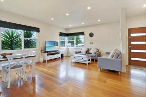 a living room with a table and a dining room at Hotham Heights in Warrnambool