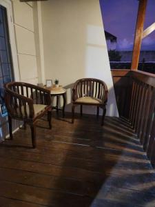 two chairs and a table on a balcony at INEZ Homestay Prawirotaman Yogya in Timuran