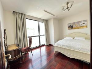 a bedroom with a bed and a chair and a window at Vinhomes Royal City 72 Nguyễn Trãi Thanh Xuân Hà Nội in Hanoi +53 photos