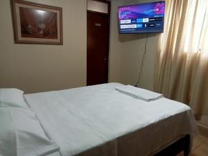 Postel nebo postele na pokoji v ubytování ROARI HOTEL