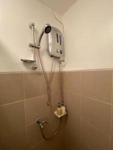 a shower in a bathroom with a shower head at GZ Studio unit- Camella Northpoint in Davao City +7 photos