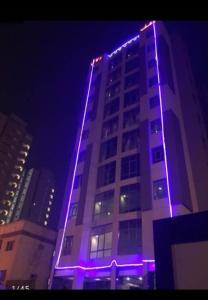 a building with purple lights on it at night at شقق رهف السالميه in Kuwait