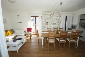 a dining room and living room with a table and chairs at Drnis Dream Apartment in Drniš