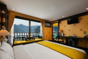 a bedroom with a large bed and a large window at Nostalgia Halong Cruise in Ha Long