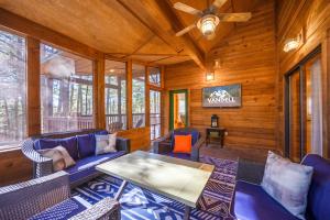 a living room with furniture and a ceiling fan at The Eastwood Spacious Retreat with 4 King En-Suites - Hot Tub - Pet-Friendly - Cozy Fire Pit - Prime Location - Multi-Family in Broken Bow