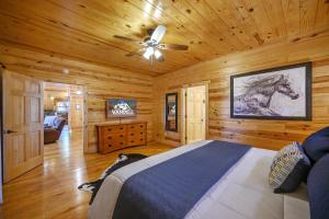 a bedroom with a bed with a painting of a horse on the wall at The Eastwood Spacious Retreat with 4 King En-Suites - Hot Tub - Pet-Friendly - Cozy Fire Pit - Prime Location - Multi-Family in Broken Bow