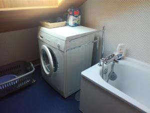 a washing machine in a bathroom next to a sink at Appart Duplex 8 pers avec Terrasse à Pra-Loup - FR-1-165A-170 in Uvernet-Fours