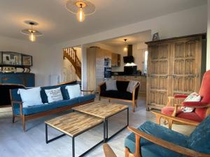 a living room with couches and a coffee table at Maison avec Jardin, WIFI, proche plage et commerces, calme - Perros-Guirec - FR-1-368-374 in Perros-Guirec