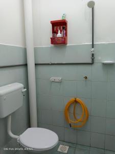 a bathroom with a toilet with a hose on the wall at OCEAN THIRTY # 15 mins to KLIA KLIA2 # with 2 Airconds & Wi-Fi in Banting