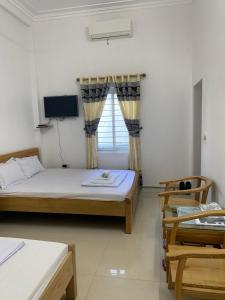 En eller flere senge i et værelse på Nhà nghỉ Chiều Tím
