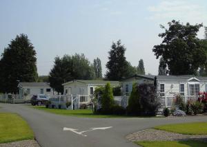 a house with a car parked in front of it at Fir Trees in Chester