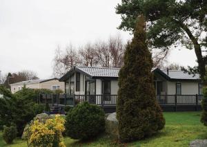 a house with a tree in front of it at Fir Trees in Chester