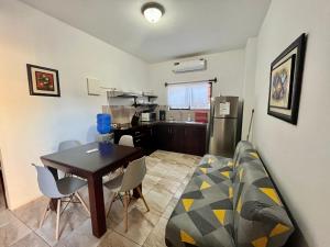 a living room with a couch and a table at Apartahotel Casa Soleil in Puerto Villamil