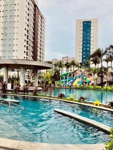 a large swimming pool in a city with tall buildings at Salinas Premium Resort in Salinópolis
