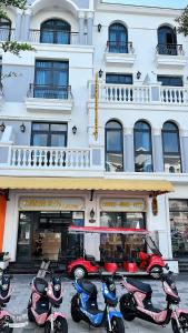 a row of scooters parked in front of a building at Ngân Hà GrandWorld Phú Quốc in Phu Quoc