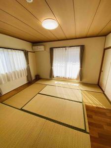 um quarto vazio com duas janelas num quarto em HOSTEL UKS - Vacation STAY 13007 em Nagoia