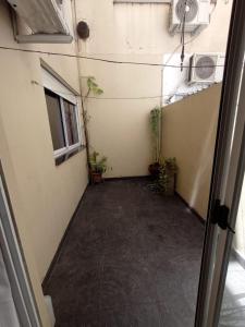 an empty hallway with potted plants in a room at Depto Caba Floresta in Buenos Aires