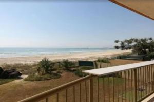een uitzicht op het strand vanaf het balkon van een strandhuis bij Palm Breeze - Hosted by Burleigh Letting in Gold Coast