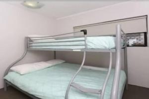 a bunk bed in a small room with a bunk bedscribed at Palm Breeze - Hosted by Burleigh Letting in Gold Coast