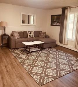 a living room with a couch and a table on a rug at North Star Place 7 in Fairbanks