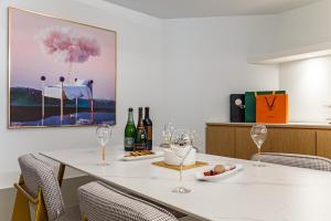 a dining room with a table with wine glasses at Brown Dot Hotel Cheonan Buldang in Cheonan