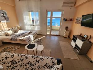 a bedroom with two beds and a view of the ocean at Beachside Studio with Sea View - Herceg Novi in Herceg-Novi