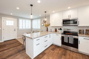 a kitchen with white cabinets and a counter top at Montara Beach Mountain Escape in Montara