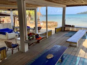 a porch with a view of the beach at CocoHuts in Koh Rong Sanloem