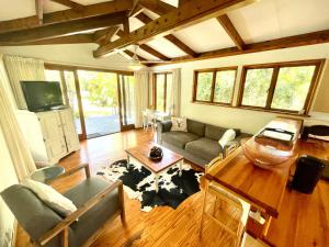 a living room with a couch and a table at Imani Bush House & Silver Sky Chalet in Hluhluwe