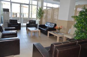 a lobby with leather couches and tables and windows at hotel kale palas in Gokceada Town