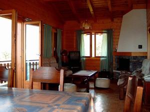 a living room with a table and a fireplace at Chalet Solina in Icogne