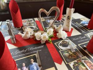 a table with a heart and some pictures on it at Gasthof Bräustübl in Selb