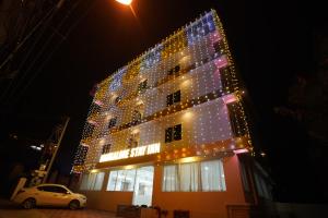 Hotel Mangalore Stay INN في منغالور: مبنى به الكثير من الأضواء عليه