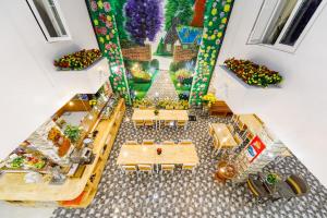 an overhead view of a dining room with tables and chairs at Golden Bee Hotel in Da Lat