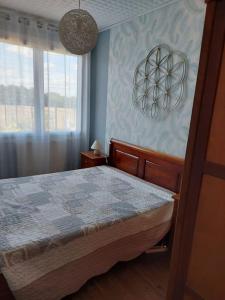 a bedroom with a bed and a window at Au coeur de la nature in Saint-Vincent-Jalmoutiers