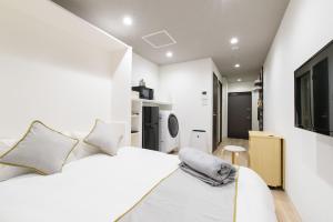 Letto o letti in una camera di JP INN Kyoto Ekimae Izutsucho