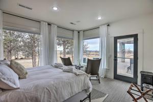 1 dormitorio con 1 cama grande y ventanas grandes en Beautiful Ranch Home with Cascade Mountain View, en Powell Butte