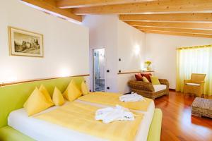 a bedroom with a large bed and a living room at Appartamenti LEON D'ORO in Riva del Garda