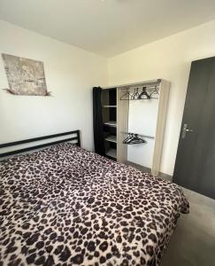 a bedroom with a leopard print bed in a room at Maison T1 bis Corse in Lucciana