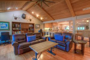 a living room with leather couches and a table at Chipmunk's Paradise condo in Kings Beach
