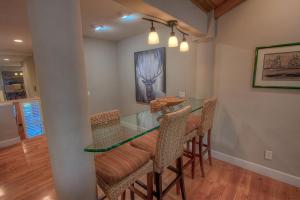 a dining room with a glass table and chairs at Chipmunk's Paradise condo in Kings Beach