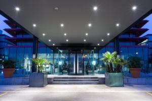 an office building with glass doors and potted plants at Best Western Plus Net Tower Hotel Padova in Padova