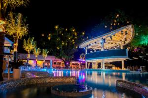a pool at night with a roller coaster at Arkbar Beach Club & Resort in Chaweng