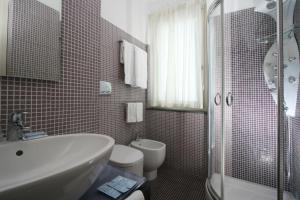 a bathroom with a sink and a toilet and a shower at Blurooms in Sorrento