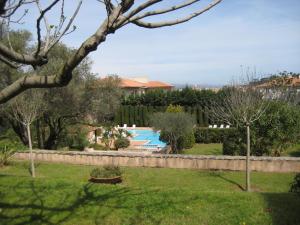 a garden with a swimming pool in a yard at St Tropez Studio in Saint-Tropez