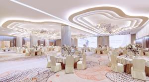 a ballroom with tables and chairs in a room with chandeliers at Nina Hotel Tsuen Wan West in Hong Kong